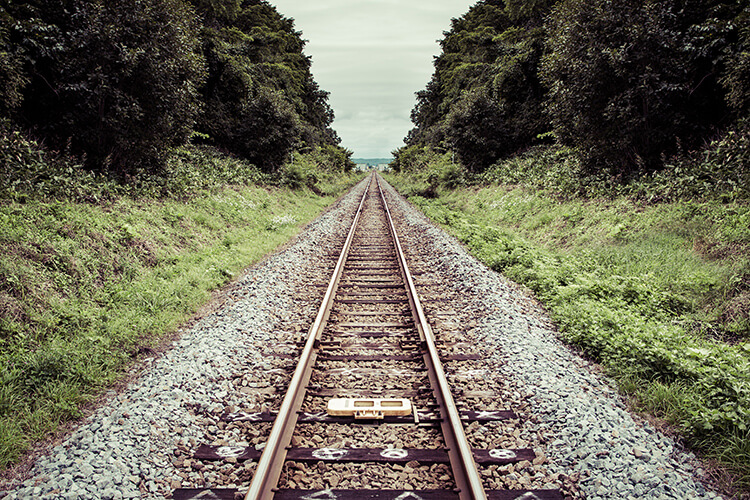 Photograph of the railroad track in a two-part composition